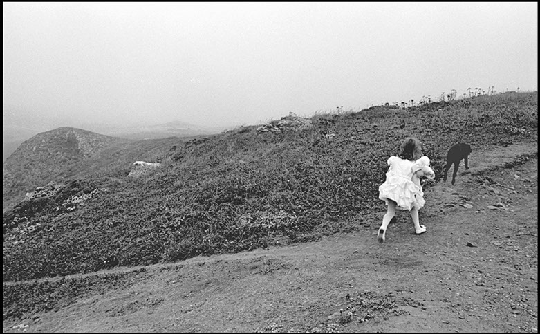 Girl running along path with dog, Russian RIver at Guerneville, California. Linda Johnson Photography, Linda Johnson Photographs.