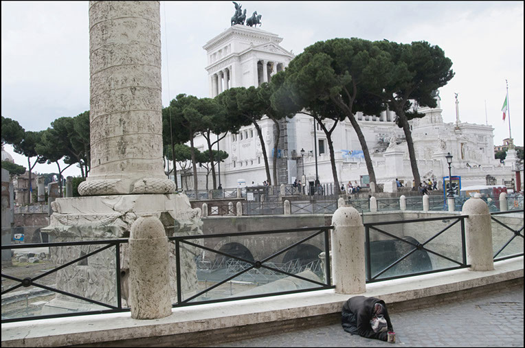 Gypsy in front of Trajan's column, Trajan's Market. In background, the Victor Emmanuel Monument in Rome, Italy. Linda Johnson Photographs